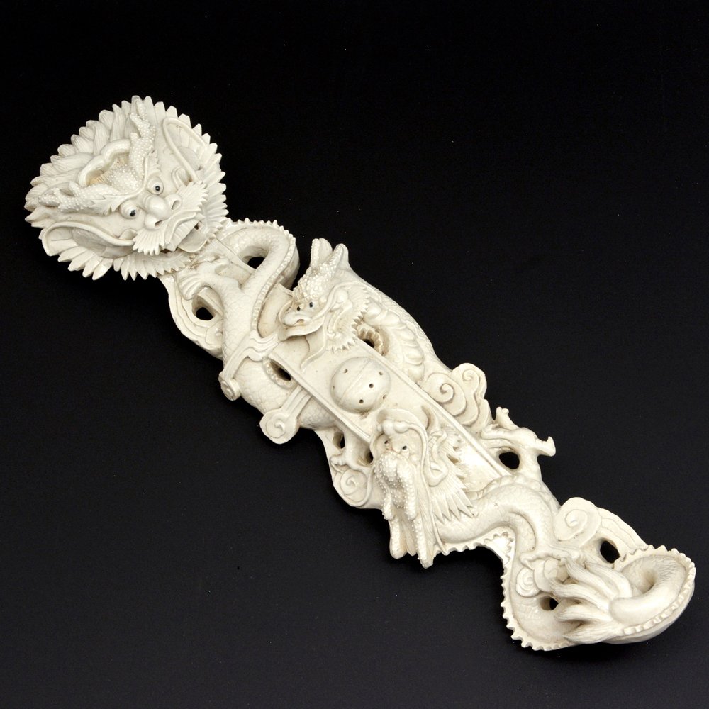 White Glazed Porcelain Dragon Ruyi Scepter: Chinese porcelain ruyi scepter, featuring three meandering dragons in pursuit of a jewel, the back marked 'Wang Bingrong zuo', 14"w