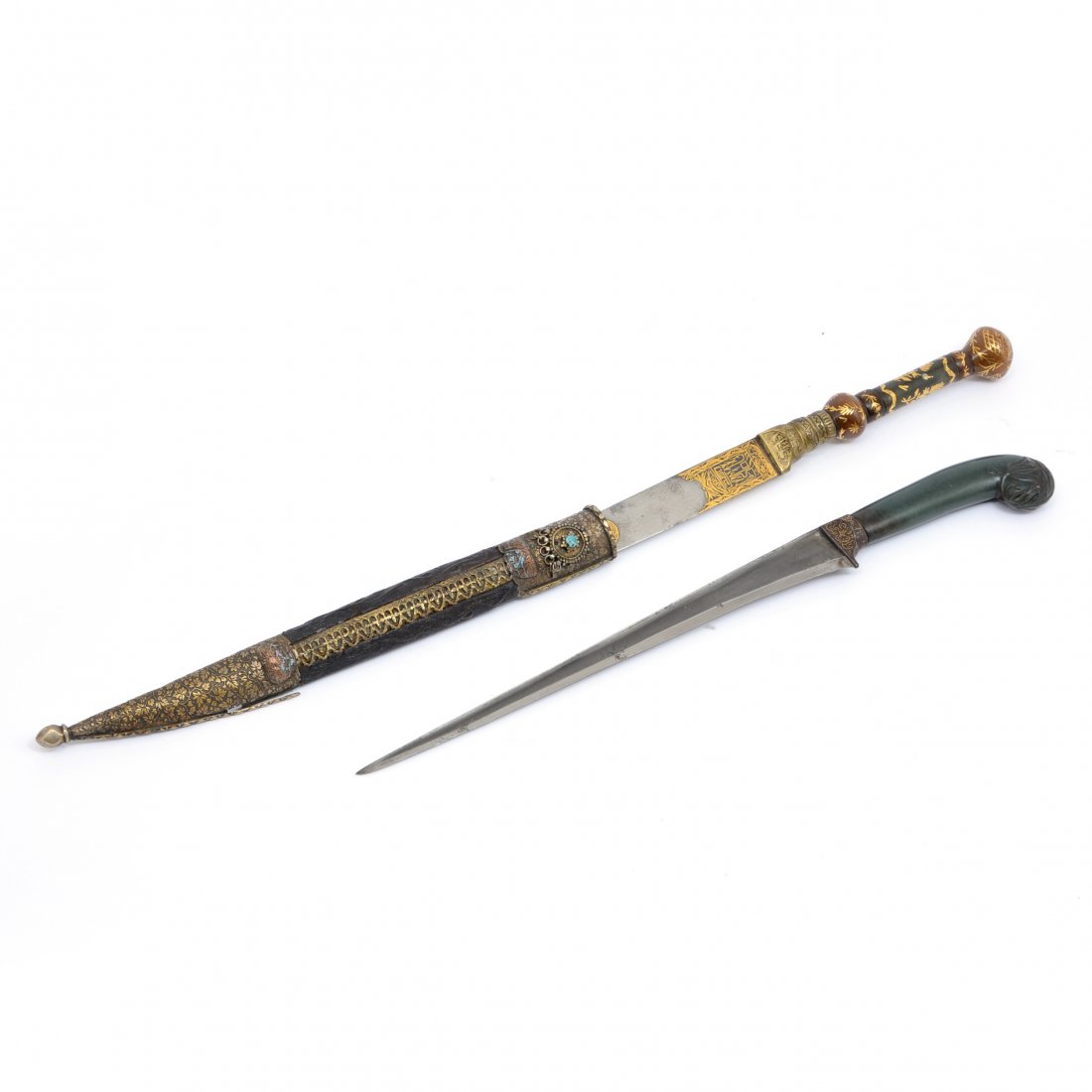 Mughal Jade Hilted Daggers (Khanjar) (lot of 2): 2 Mughal Jade Hilted Daggers (Khanjar) each with rich green jade handle and rolled pommel, one carved with lotus flowers, the other decorated in gilt. Length 14.5". Provenance: Estate of Karl Isenberg