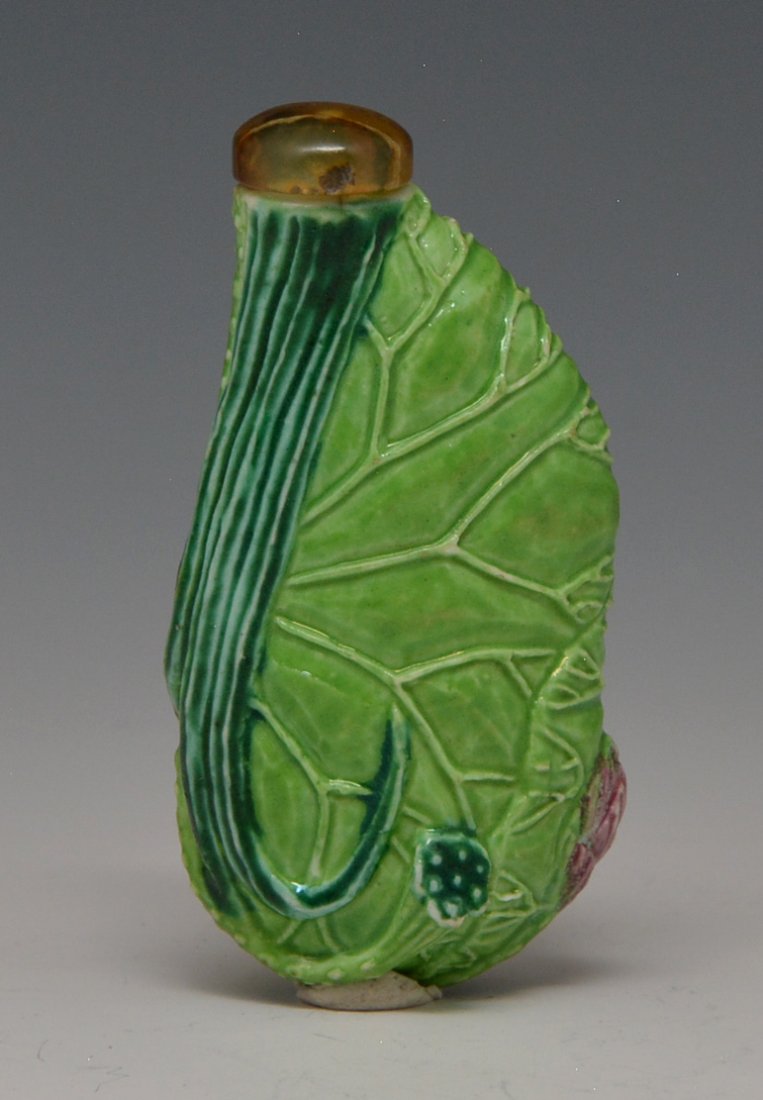Green porcelain lotus leaf snuff bottle: Green porcelain lotus leaf snuff bottle. Kuang Hsu late Ching period. Height with stopper 2½ inches. Purchased from Yuan Feng & Co. Ltd., Hong Kong, China 7/15/1970