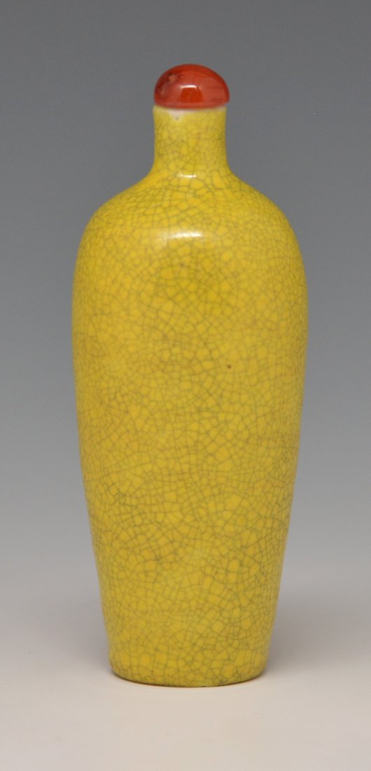 Antique porcelain imperial yellow snuff bottle: Antique porcelain imperial yellow bottle monochrome with tiny crackle glaze. Height with stopper is 3½ inches. 18th c. Purchased from Yuan Feng & Co. Ltd., Hong Kong, China 8/21/1970