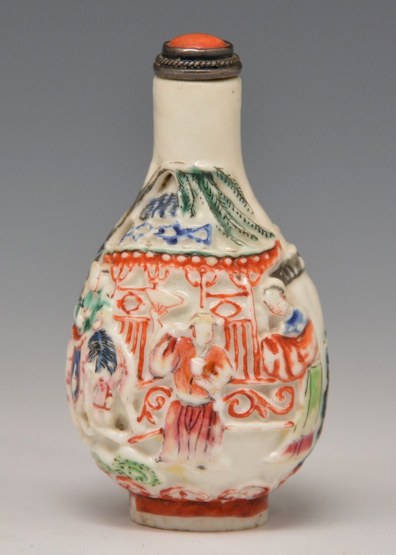 Chinese porcelain snuff bottle, Early Qing Dynasty: Chinese porcelain snuff bottle molded and decorated showing a meeting of a lady and a pink coated man outside a house with a horse and rickshaw to one side with blue, red, and green enamels in a brigh