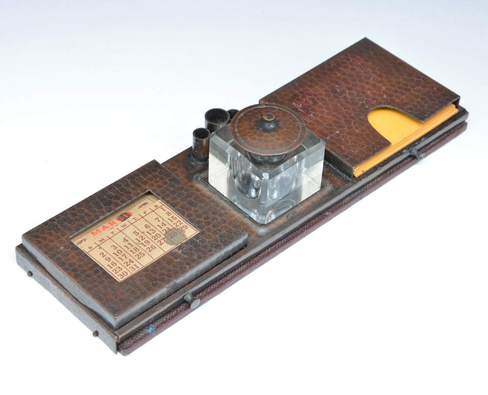 Roycroft Hammered Copper Inkwell & Deskset: Roycroft Hammered Copper Inkwell & Deskset. includes inkwell, 3 pen holders, calendar, memo pad and pull-out daily minder, 11.75" x 3.75" closed, orb & cross mark and in original patina.