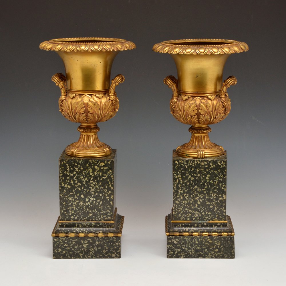 Pair of Gilt Bronze Urns on Granite Plinths, 17.5"t: Pair of Gilt Bronze Urns on ormolu mounted granite plinths, 17.5"t, now electrified, good condition with some losses and separations to the bases.