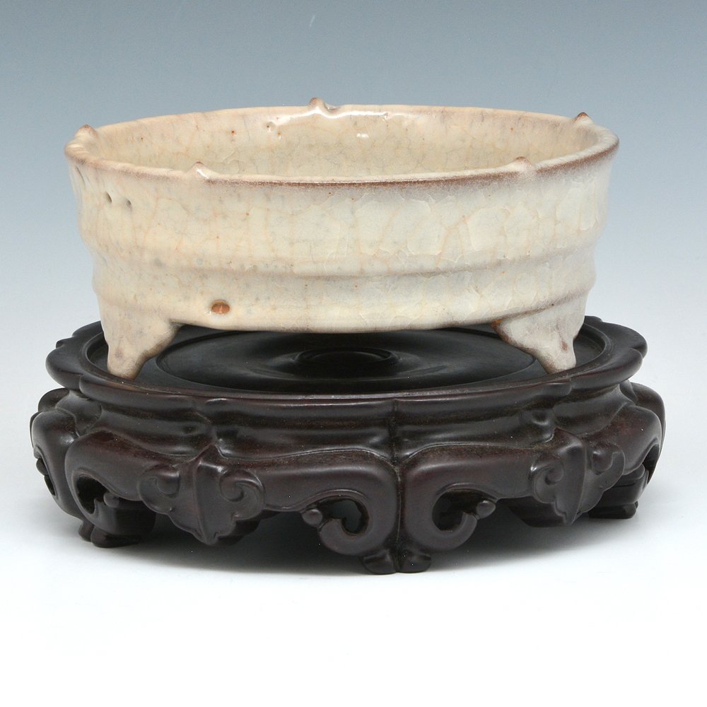 Kwan-Type Brush Washer: Kwan-Type Brush Washer. The circular shallow body decorated with a raised band, and supported on three ruyi shaped legs, covered all over with rich smooth grayish-blue glaze suffused with network of g