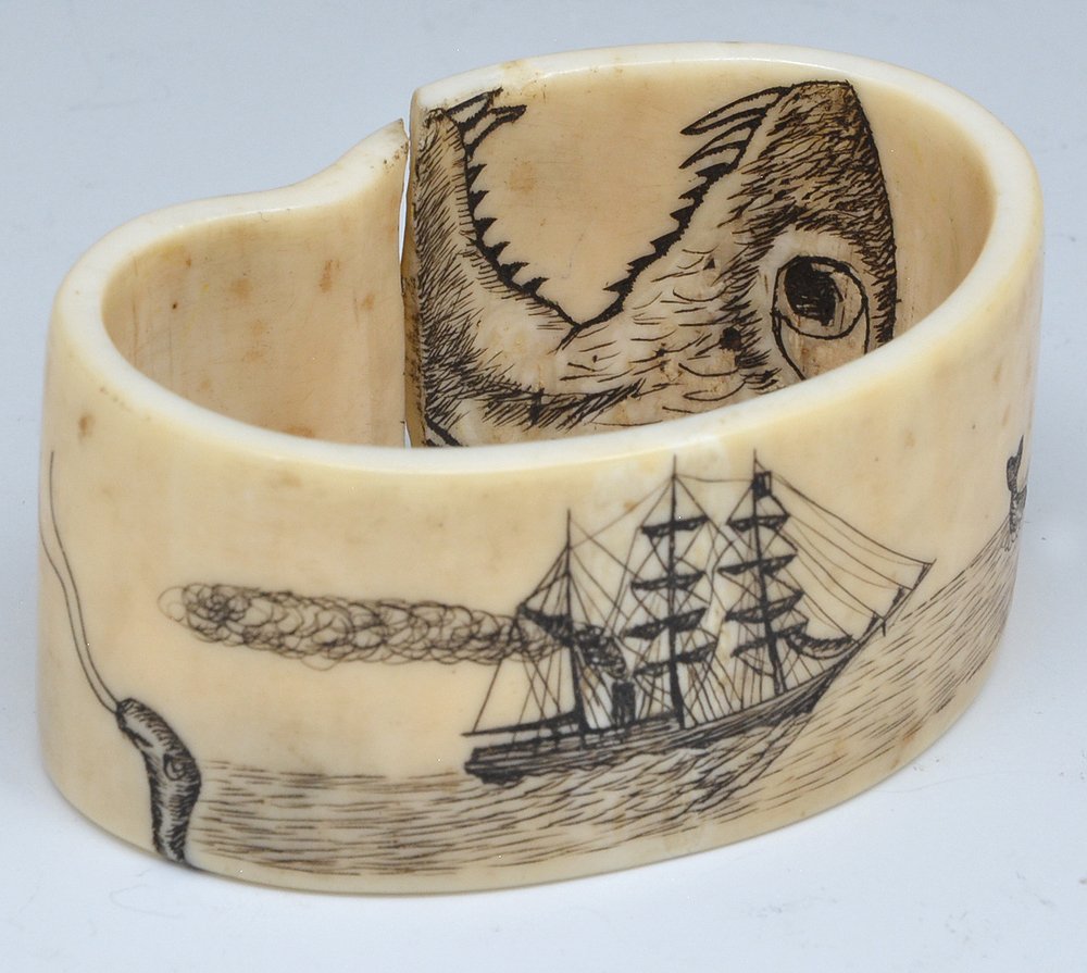 Eskimo walrus bracelet with whaling scrimshaw: Eskimo walrus cuff bracelet with whale boat, whaling and breeching whale scrimshaw. Unfortunately, crack with separation on bottom. 1 3/8"t x 2 3/4"w.