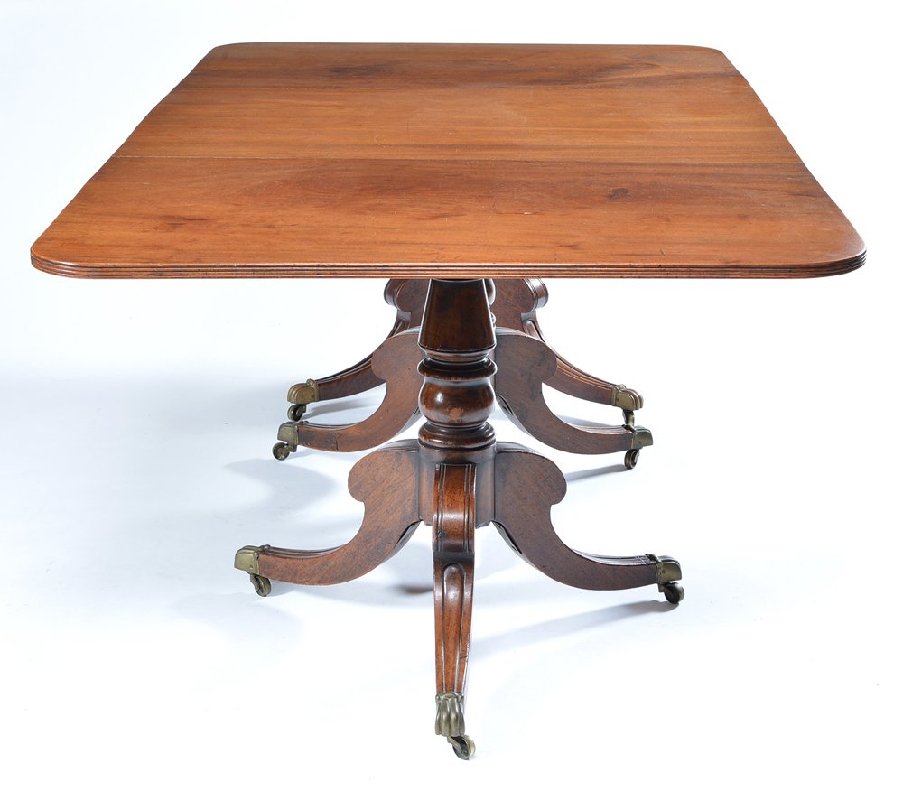 Duncan Phyfe Style Centennial Pedestal Table: Duncan Phyfe style centennial English mahogany oblong three-pedestal table with brass claw feet with castors. Includes two 16" leaves, total length with leaves appx 119".