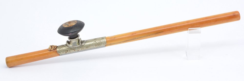 19th c Chinese Opium Pipe: 19th c Chinese opium pipe: body with sculpted face decoration, silver saddle with incised bat decoration, wood bowl with marked inset. Missing end cap. Length appx 18 3/4".