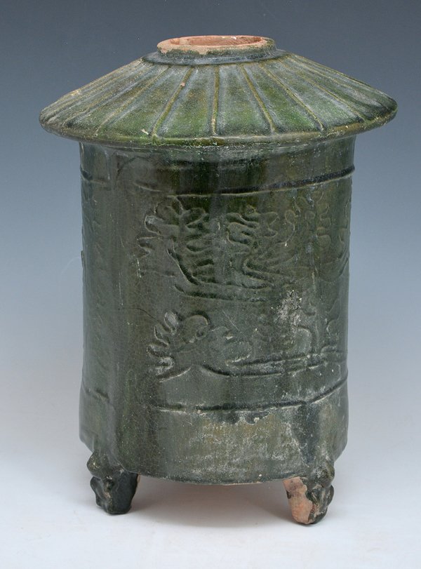 Chinese Han Dynasty Clay Grainery: Chinese Han dynasty clay grainery with open top, tri-foot base, green glazed with foliate decoration. Appx 11 1/4"h x 8 1/2"d.