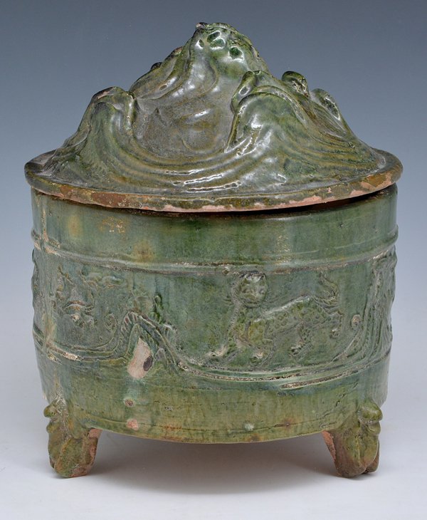 Chinese Han Dynasty Green Glazed "Hill" Censer: Chinese Han Dynasty green glazed pottery tripod base "hill" censer with cover, decorated with a band of mythical beasts in relief. The cover is a stylized hill. All in a partially iridescent green gla