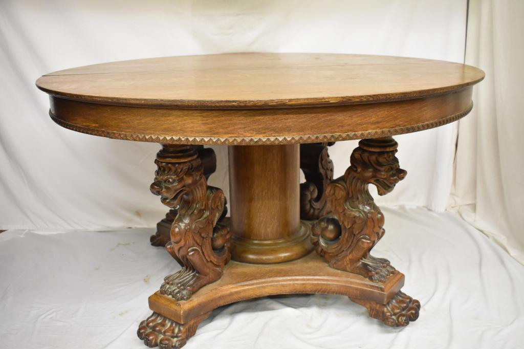 Heavily Carved Round Oak Dinining Table: Round oak dining table with heavily carved legs and feet. Lions or griffin carvings. Local pick up only. 51" diameter. Local pick up only. Dr. Michael O'Banion estate.