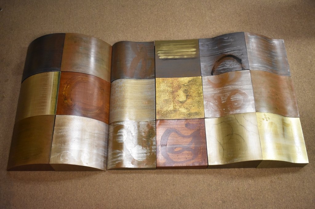 Monumental Phoenix Art Group Metal "The Cell" Art: Tile art "The Cell" . Painted in grays, gold, silver, muted rust, browns an black.. Each cell or tile is unique. The cells form a flowing wall design. Consists of 18 cells, each numbered on back, and 