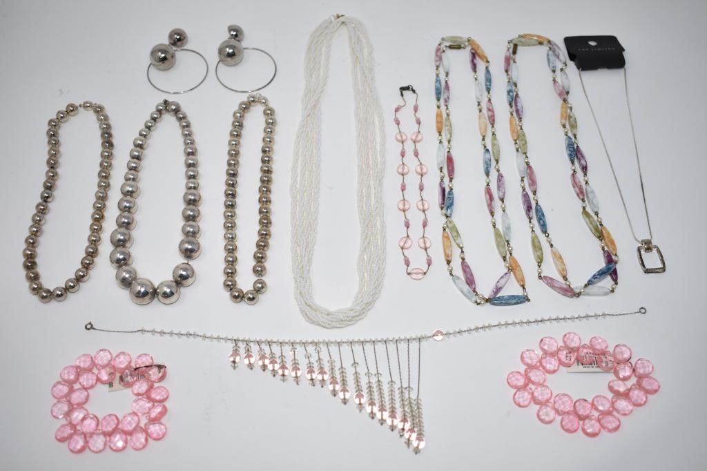 Group of Costume Jewelry, 12 Pieces: Two Limited stretchy bracelets, unmarked beaded necklace, two pink necklaces, three silver bead necklaces, pair silver bead earrings, two rainbow bead necklaces.