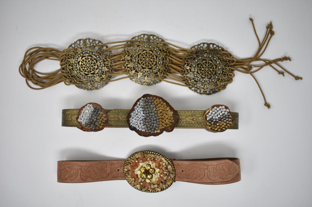 Three Belts: Leather Carol & Louis belt with cross sections of geodes adorned with metal faceted beads. Express leather belt with rock covered buckle. Express rope medallion belt. All size smalls.