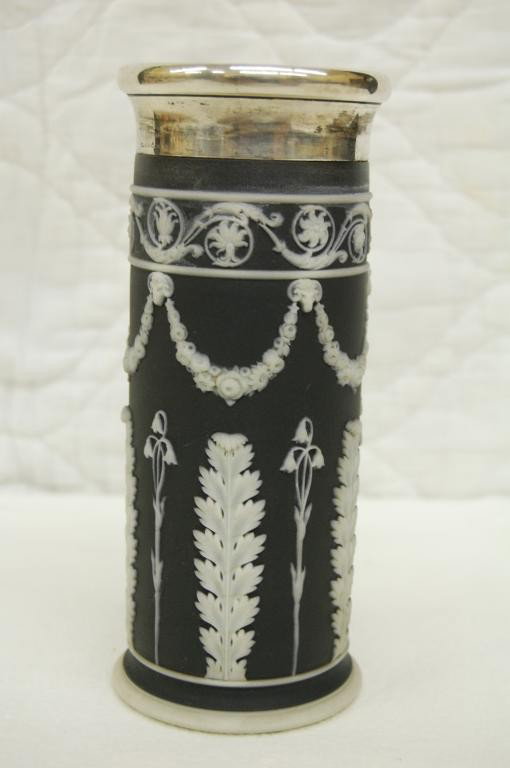 c. 1880 WEDGWOOD BLACK JASPERWARE SPILL VASE: SILVER MARKED WITH A CROWN 800 ? D.H. BOTTOM OF VASE MARKED WEDGWOOD 6 H AND 3 INCISED DOTS. NICE DETAIL. HAS RAM HEADS HOLDING UP LORALS. BELL FLOWERS. ALMOST 6 3/4 INCHES TALL.