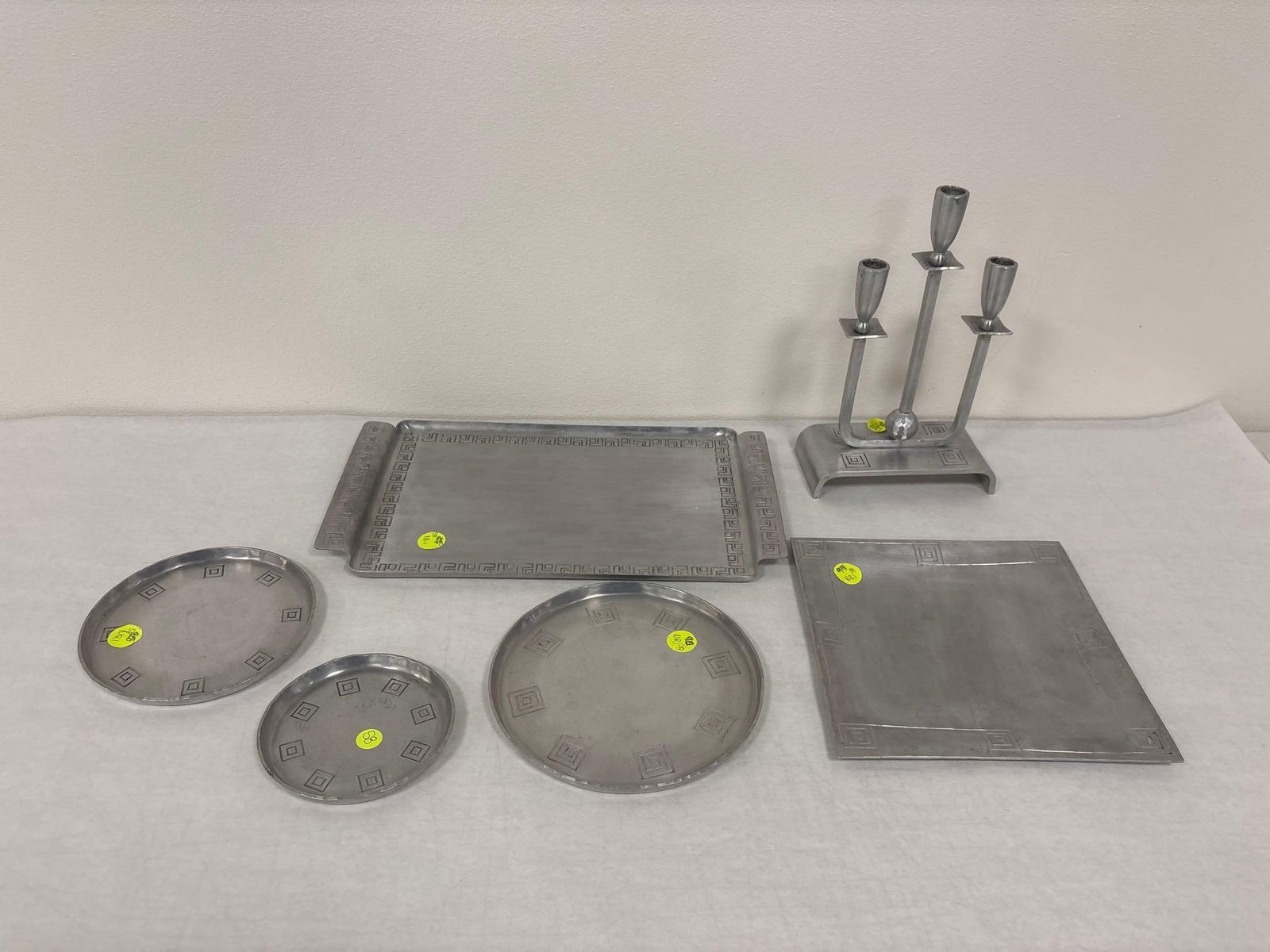 Palmer Smith Hammered Aluminum Serving Dishes: Check out this set of six Palmer Smith hammered aluminum serving dishes and candelabra. These pieces feature the Greek Motif. These would be perfect for a candle lit, build your own Gyro, family dinne