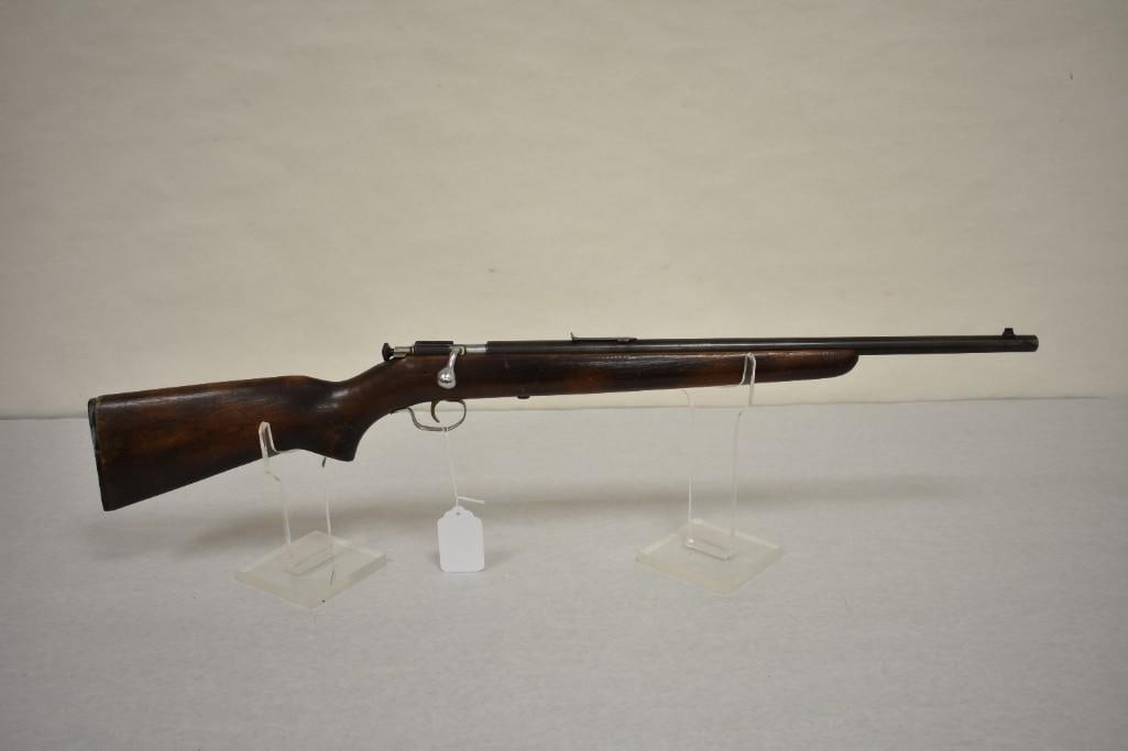 Gun. Winchester Model 67A .22 LR Rifle.: Bolt action single shot rifle. 20in barrel has a good bore. Post and notch sights. Missing rear sight elevator. Some blue remains. Hardwood stock with plastic buttplate. SN: N/A. Condition: Good. 11-5
