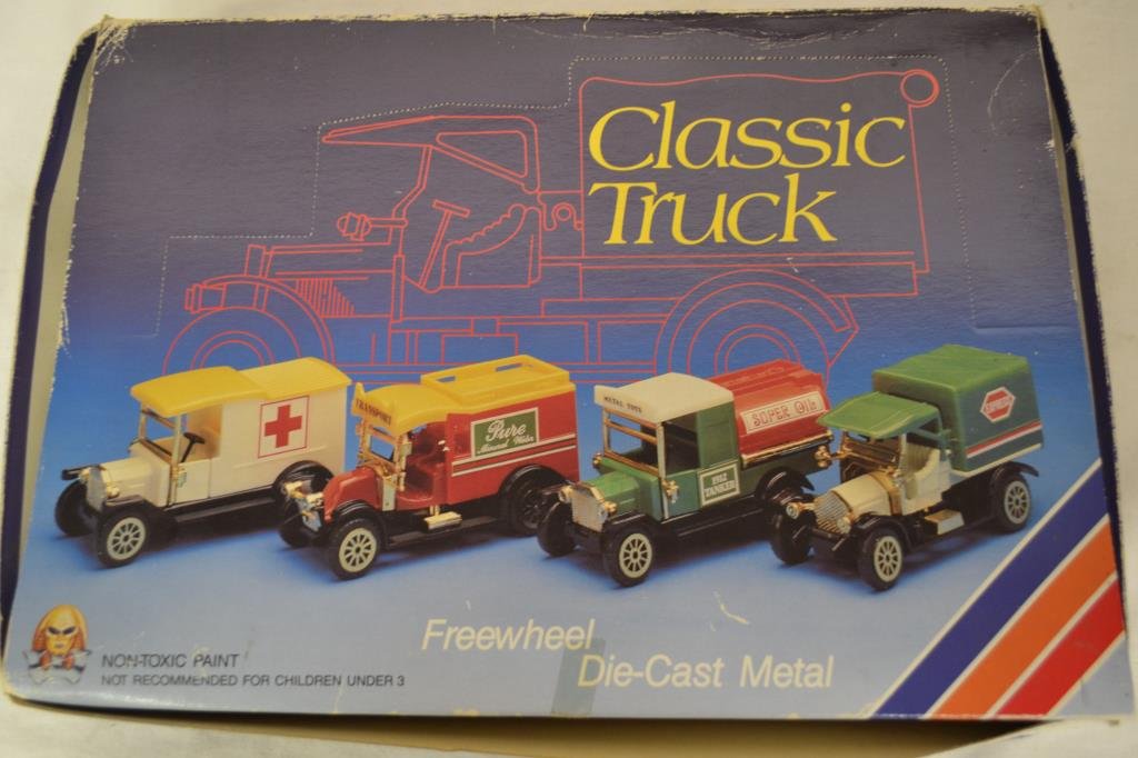 12 Assorted Sinclair Gasoline Toy Trucks in Box: Die Cast metal freewheel non-toxic paint. Box has some dents and loss.