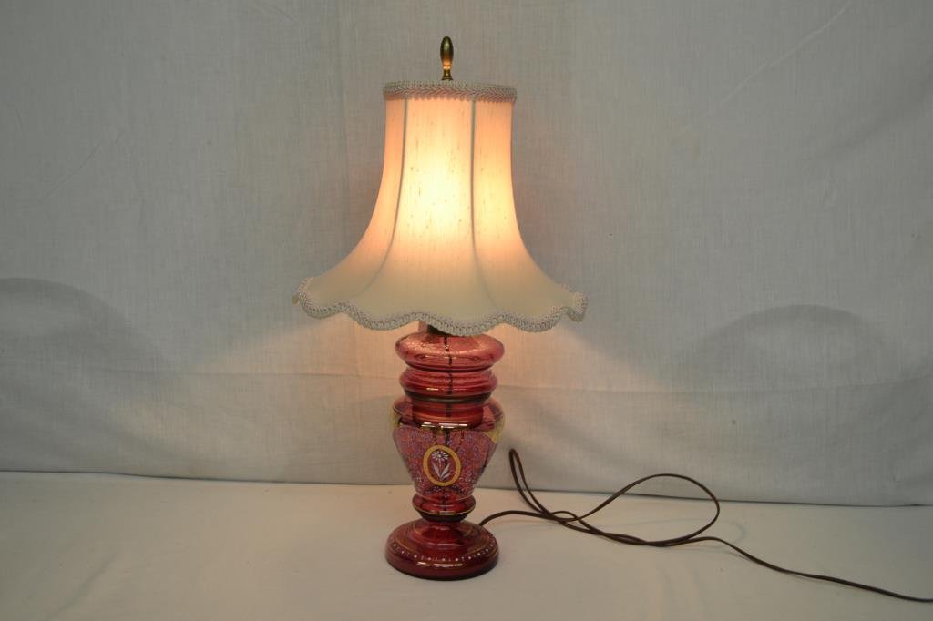 Cranberry Enameled Electric Desk Lamp: Base is made from a covered cranberry lidded jar. White and gold embellishments. Light pink shade. Stands 23.5" to top of finial.
