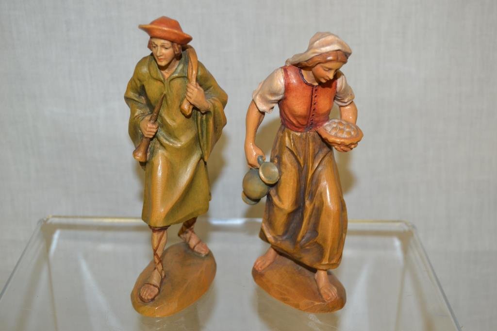2 Anri Hand Carved Wooden Figurines: 6" tall. Gentleman holding a flute and a lady with an ewer and bowl.