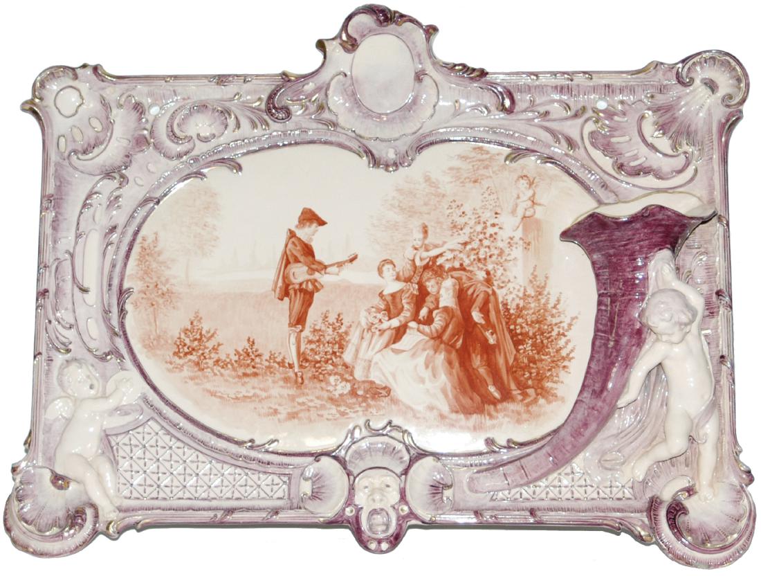 Uncommon Mettlach 23x17 Plaque w Relief Cherubs: Mettlach #2353/6023 PUG 23” by 17” Plaque. Relief cherub and horn of plenty. Sepia and purple coloring. Uncommon.