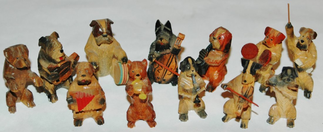Group of Twelve Carved Wood Dog Musicians: Nice group of twelve carved wood 2" dog figures playing musical instruments, accordian, guitar, base fiddle, drum, French horn, Symbols, Sax, clarinet, flute, violin, and conductor.