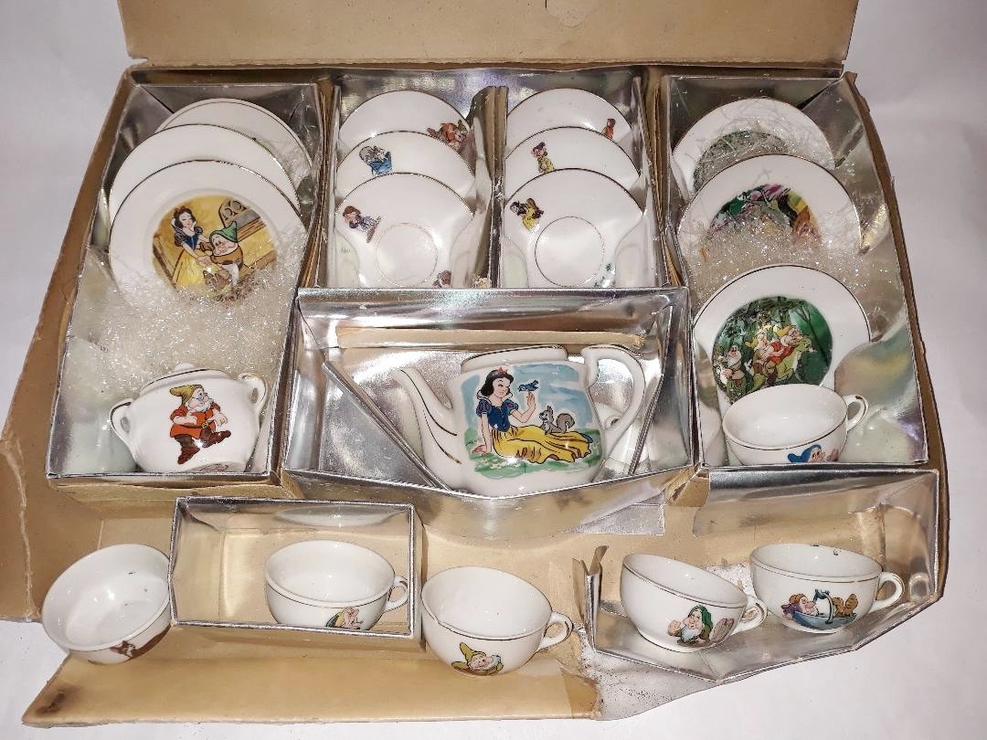 Vintage Marx Toys Walt Disney Productions Tea Set Beaut: A 1950s Marx Toys Disney tea set. This miniature porcelain tea set for children features white serving pieces with colorful Walt Disney characters from the 1938 Snow White and the Seven Dwarfs. There