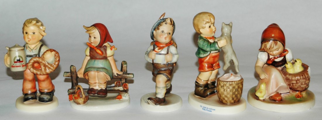 Group of five Hummel figures: Group of five Hummel figures. 1) Boy holds pretzel and beer stein 4". Mint. 2)Girl sits on fence 3 7/8". Mint. 3)Boy with back pack 4 1/2". Large Bee mark. Mint. 4) Boy holds kitten 4 1/2". Mint. 5) G