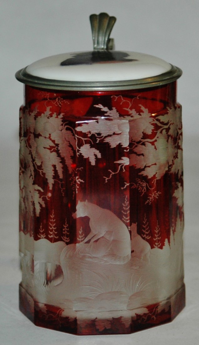 Blown Glass 3/10L stein wheel-cut wolf: Blown Glass 3/10L. Ruby stained and wheel-cut wolf scene on faceted body. Porcelain inlay of bird. Mint.