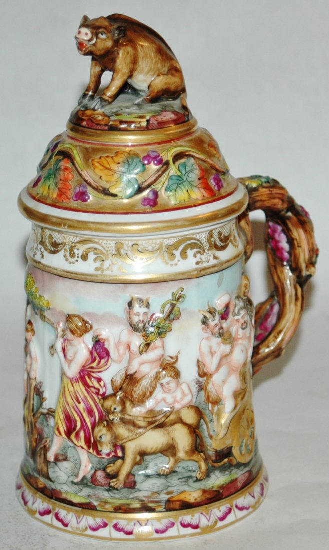 Capo-di-Monte Hand painted relief Bacchus scene stein: Porcelain Capo-di-Monte 1/2L. Romanesque scene of Pan and Bacchus. Set on lid with boar finial. Mint.