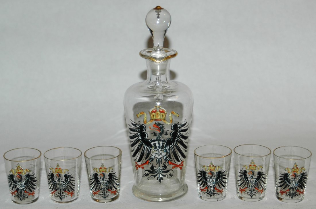 Blown Glass decanter with six matching shots with eagle: Blown Glass 7” Decanter Bottle with six 2” shot glasses. Each enameled with Imperial Eagle. All are mint.