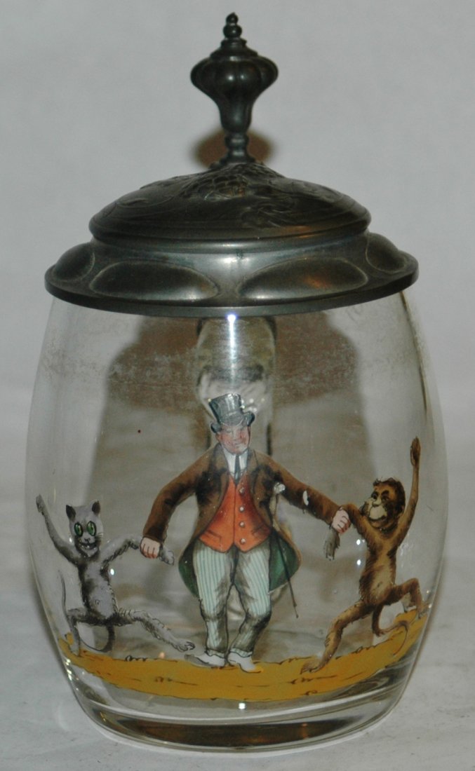 Blown Glass enameled man and monkey stein: Blown Glass 1/2L. Enameled scene of man holding monkeys by the hand. Fancy relief pewter lid. Mint.