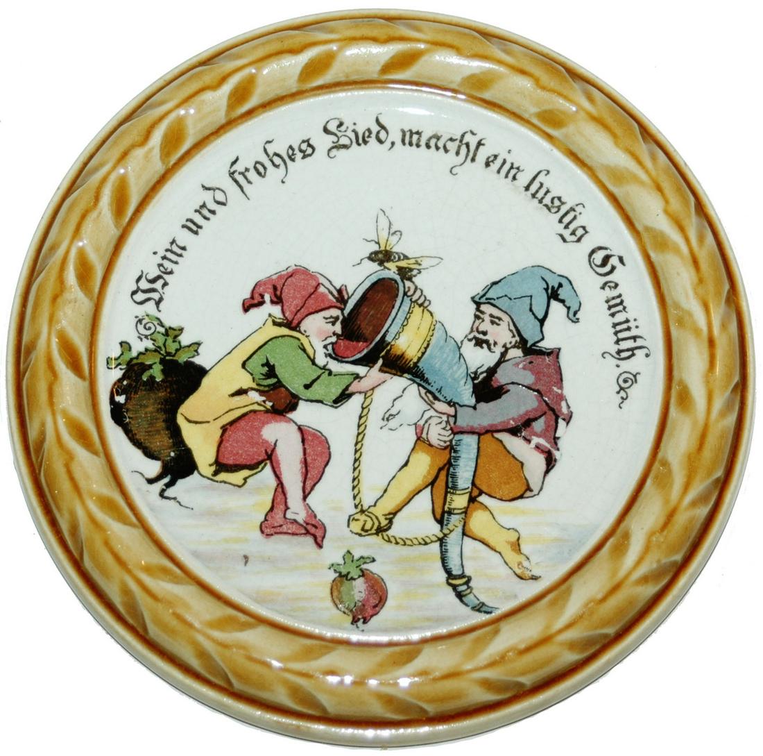 Mettlach Coaster Dwarf w Large Drinking Horn: Mettlach #1032 PUG 5” Coaster. Dwarfs hold large drinking horn. Mint.