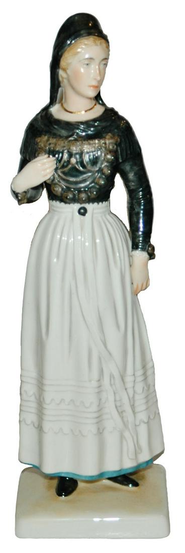 Allach Porcelain Woman Figurine SS mark on Base: Allach Porcelain 8 1/2” Figure. Woman in ethnic dress. SS mark on the base. Mint.