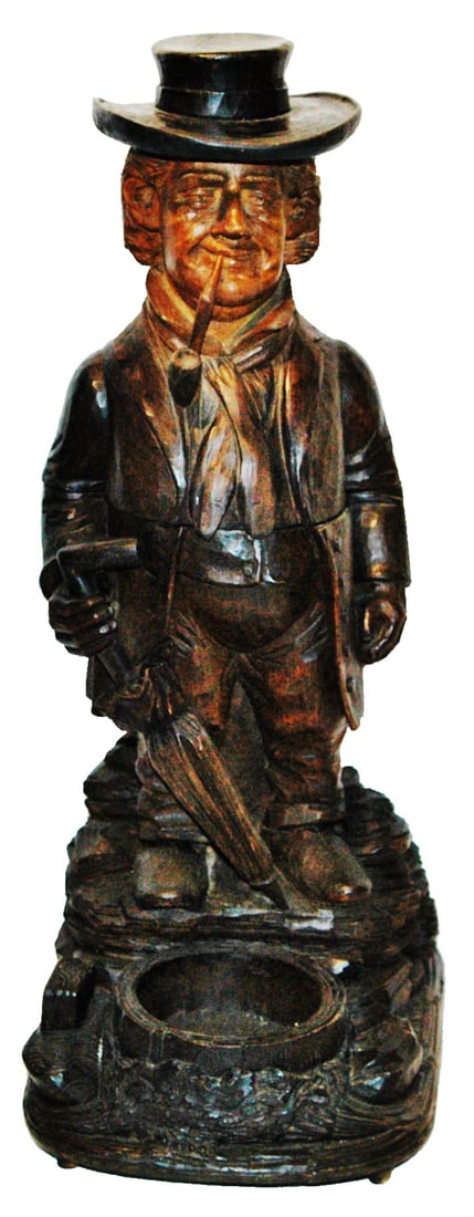 Black Forest Carved Musical Dressy Man Humidor: Black Forest Carved Wood 17” Musical Tobacco Humidor. Man wears hat and holds umbrella. Music activated when you open the hinged lid. Normal wear.