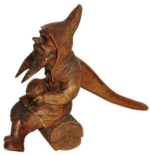 Black Forest Carved Dwarf on Log Nutcracker: Black Forest Carved Wood 6” Nutcracker. Dwarf sits on log with nut in his lap.