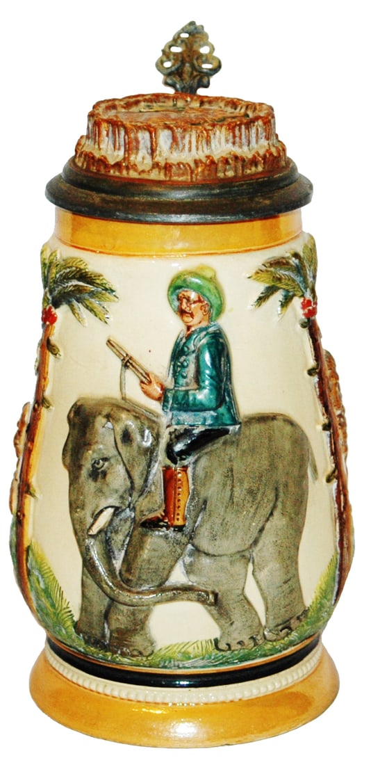 Teddy Roosevelt on Elephant on Safari Stein: Pottery Relief 1/2L. Teddy Roosevelt rides elephant on safari. Stag horn shaped inlay lid and handle.