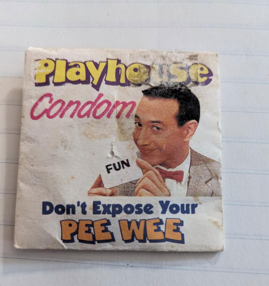 1980's Paper Playhouse Condom Envelope - Pee Wee Herman with 1 Original Condom: 1980's Collectible Paper Condom Container. PLAYHOUSE CONDOM. Features Paul Reubens as Pee Wee Herman. Says Don't expose your Pee Wee on the front. Back say, "This could be Pee Wee's Greatest Adventure