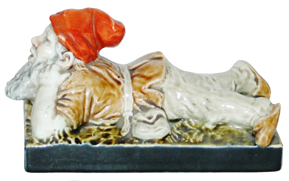 Villeroy & Boch Reclining Dwarf Paperweight: Villeroy & Boch Dresden 7” by 3 1/2” Paperweight. Bearded dwarf laying down. Mint.