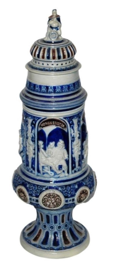 19" Pokal w Four Landsknecht w Gamrinus Finial: Stoneware Relief 19” Pokal. Four panels of Landsknecht. Set on lid. with Gambrinus finial.