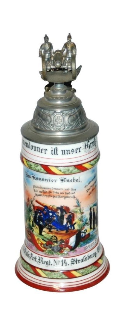 Regimental Fuss Art No 14 Crew Top Cannon Stein: Regimental Stein 1/2L Porcelain. “6 Comp. Bad. Fuss Art. Regt. No 14 Strassburg 1903-05, Res. Kanonier Knebel.” Two side scenes. Rear roster. Crew top cannon finial. Mint.