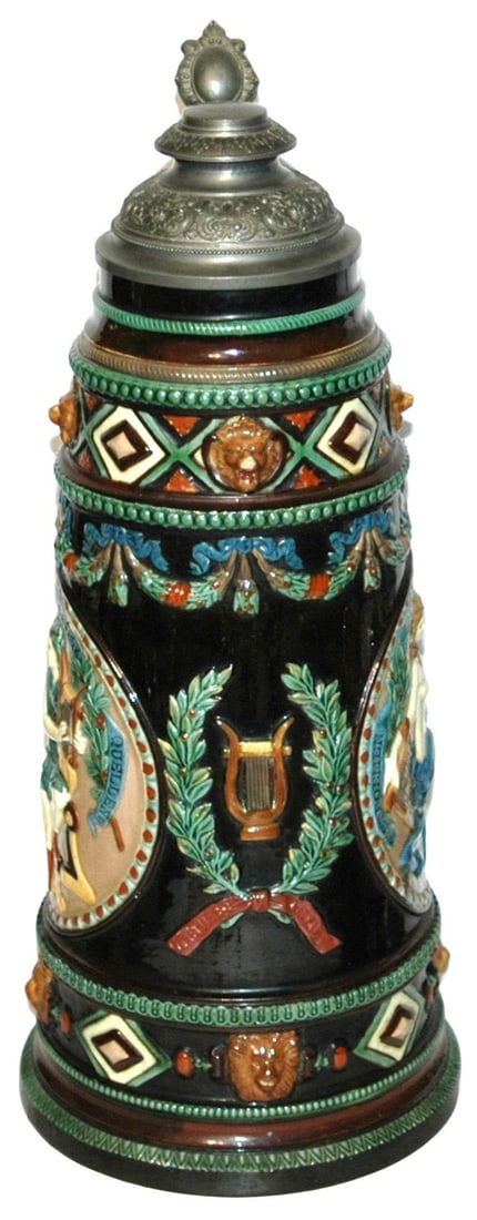 4L Majolica Women Lion Faces & Garland Stein: Majolica #46 Relief 4L 16”. Women play harps, one is semi nude. Lion faces and garland. Mint.