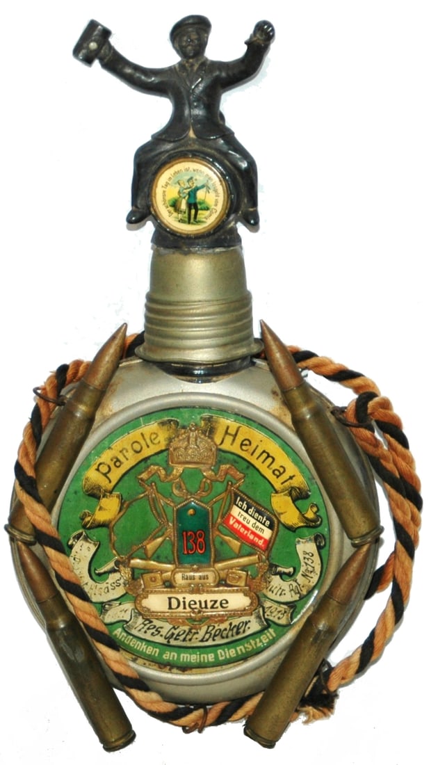 Regimental Flask Applied Bullets Soldier Screw Cap: Regimental Flask Metal & Glass. “138 Inft. Regt. Res. Gefr. Becker.” Four scenes on rear and one seen within the flask. Applied bullets. Soldier on barrel screw cap. Soldier scenes on both