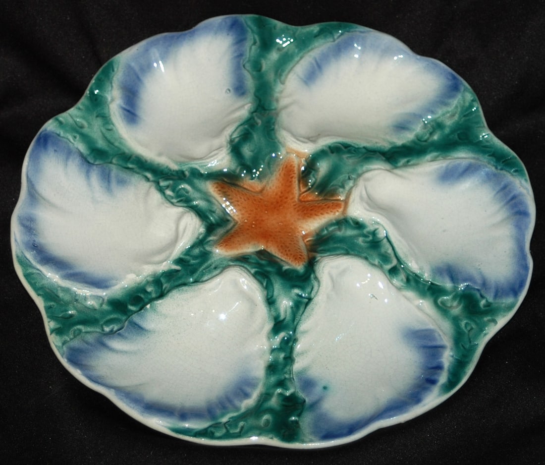 Majolica Oyster Plate Starfish centered in 6 Wells: Majolica 10 1/2" Oyster Plate. Starfish in the middle of 6 wells. Mint.