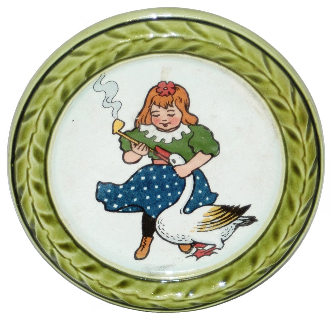 Mettlach Girl w Pipe and Duck Coaster: Mettlach #1264 PUG 4 3/4” Coaster. Girl gives pipe to duck. Mint.