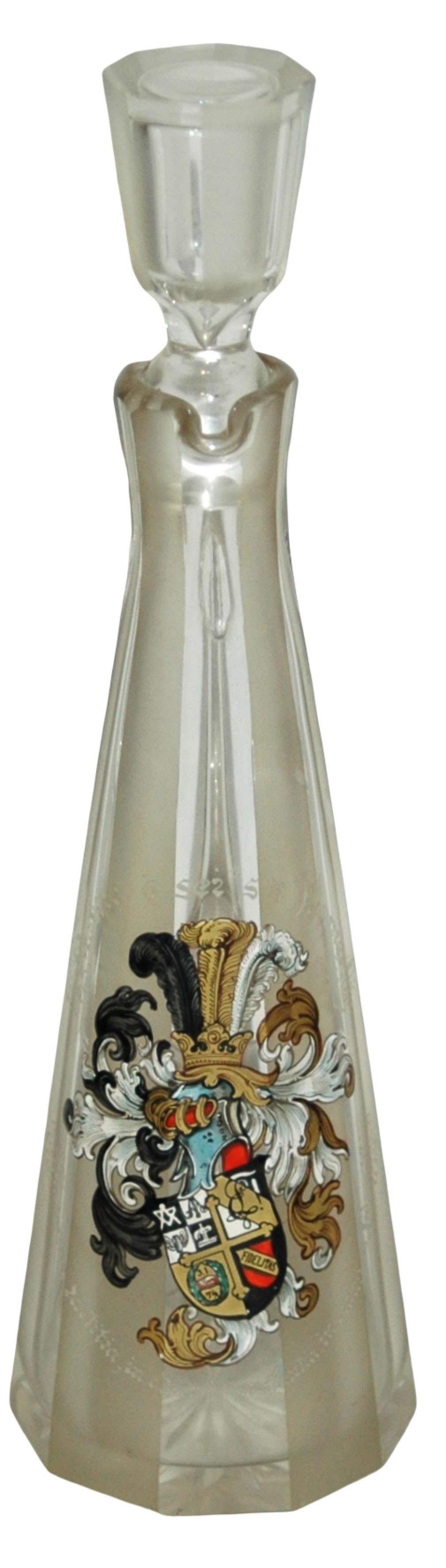Glass Decanter Dueling Fraternal Student Shield: Blown Glass 11 ½" Decanter. Enameled dueling fraternal student shield on alternating frosted and clear faceted body. "Pactitia sei's Panier!" Matching stopper.