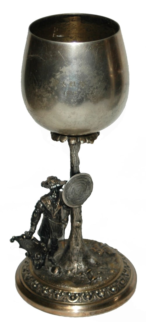 10" Marksman w Crossbows & Target Goblet: Brass 10” Figural Goblet. Marksman with crossbows stands next to target. Engraved “F & H.W. 1915.”