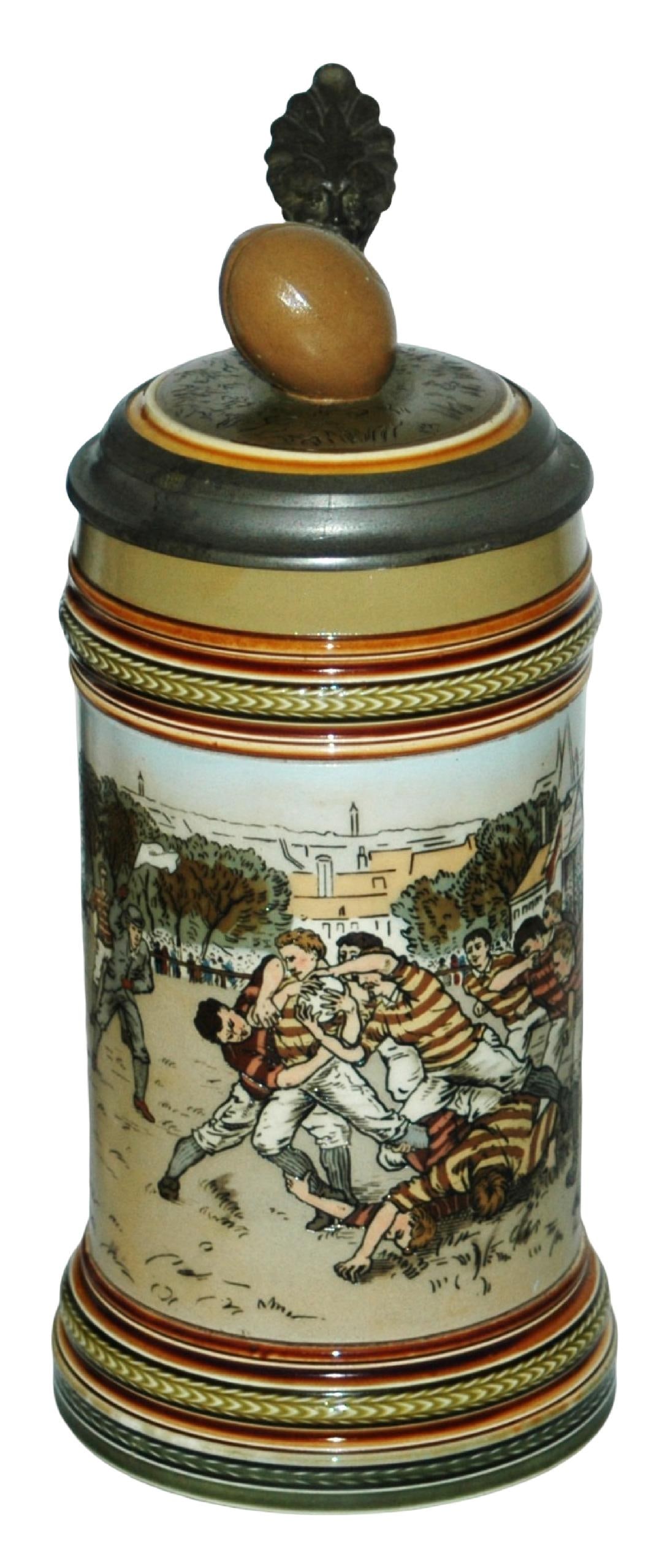 Mettlach First American Football Game Stein w Lid: Mettlach #2324 Etched 1/2L. Scene of the first American football game. Football finial on inlay lid. Mint.