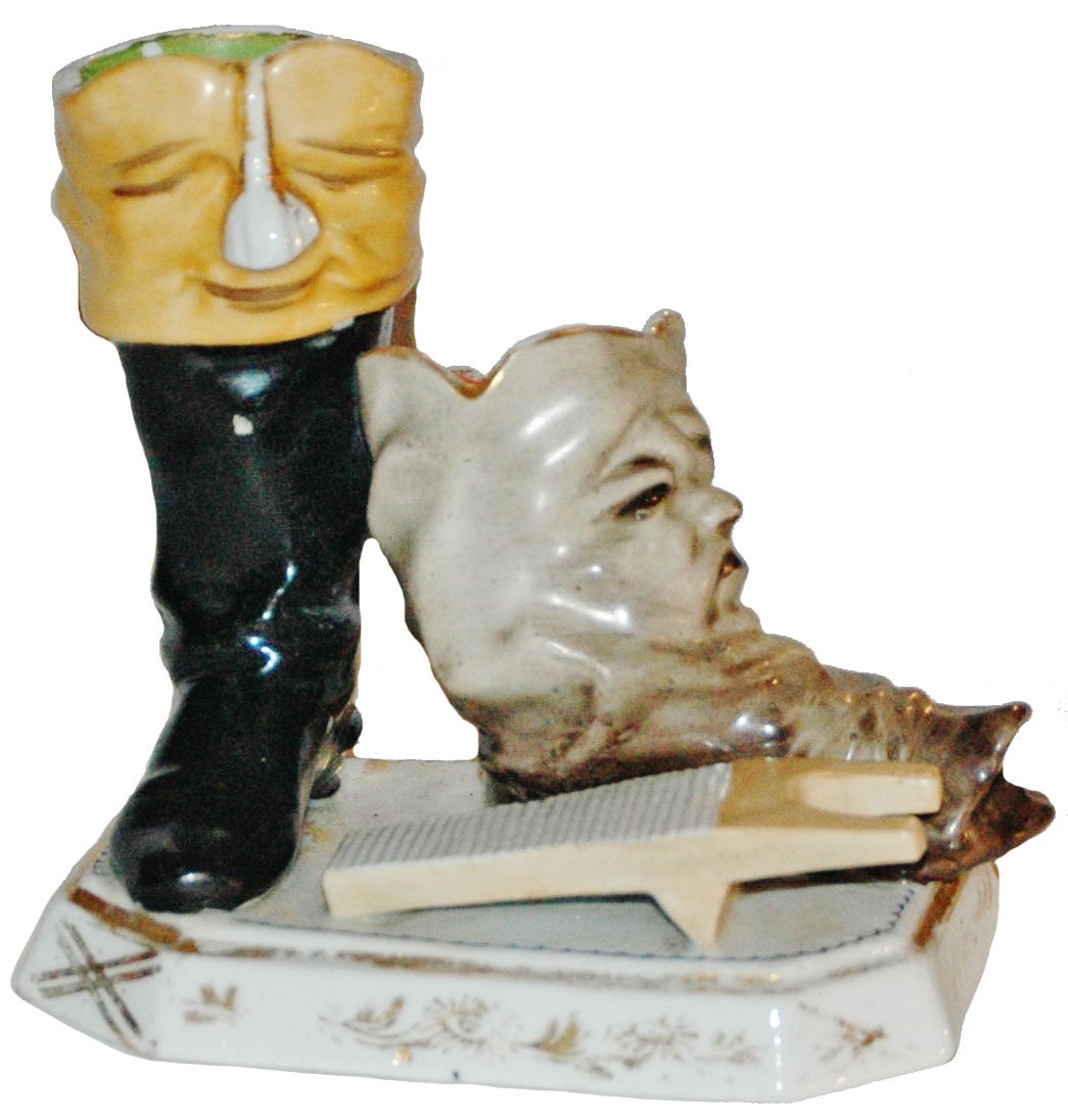 Character Boots Match Striker Porcelain Figure: Porcelain 4" by 4 1/2" Figure. Character boots with faces match striker.