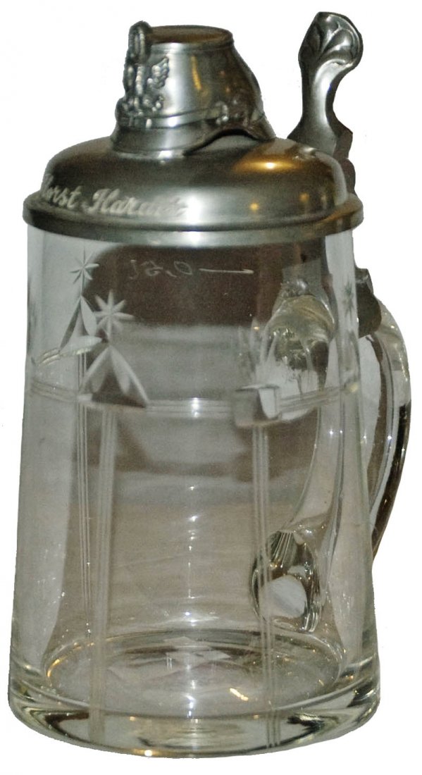 Jager Glass Stein w Helmet Lid & Inscription: Blown Glass 1/2L. Cut line design. Figural helmet lid with engraved name “Horst Harder” on top of lid. Regimental service engraved “Jager Bt. Ratzeburg 1908-10” on underside of lid. Mint.