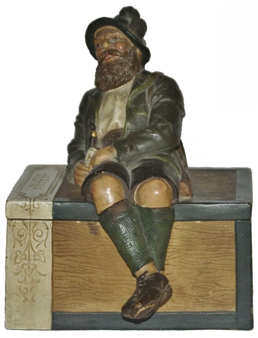 Terracotta Bavarian Man on Box Tobacco Jar Maresch: Jon Maresch #3338 Terracotta 8" Tobacco Jar. Cigar box with figural Bavarian man on set on lid.